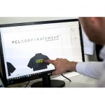 Man pointing at a bespoke uniform on a screen