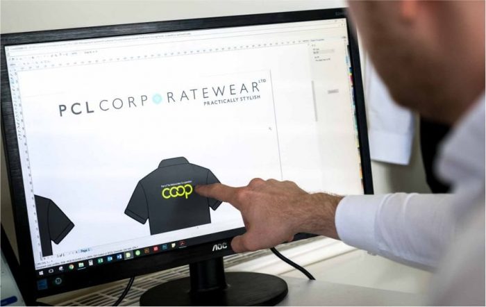 Man pointing at a bespoke uniform on a computer screen