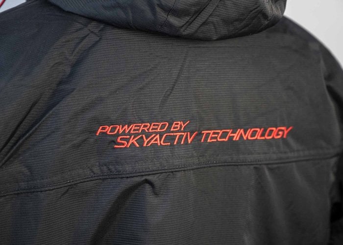 Mazda embroidery on back of black jacket