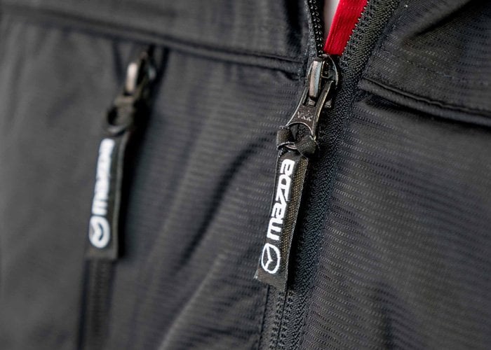 Mazda zip pulls on black jacket