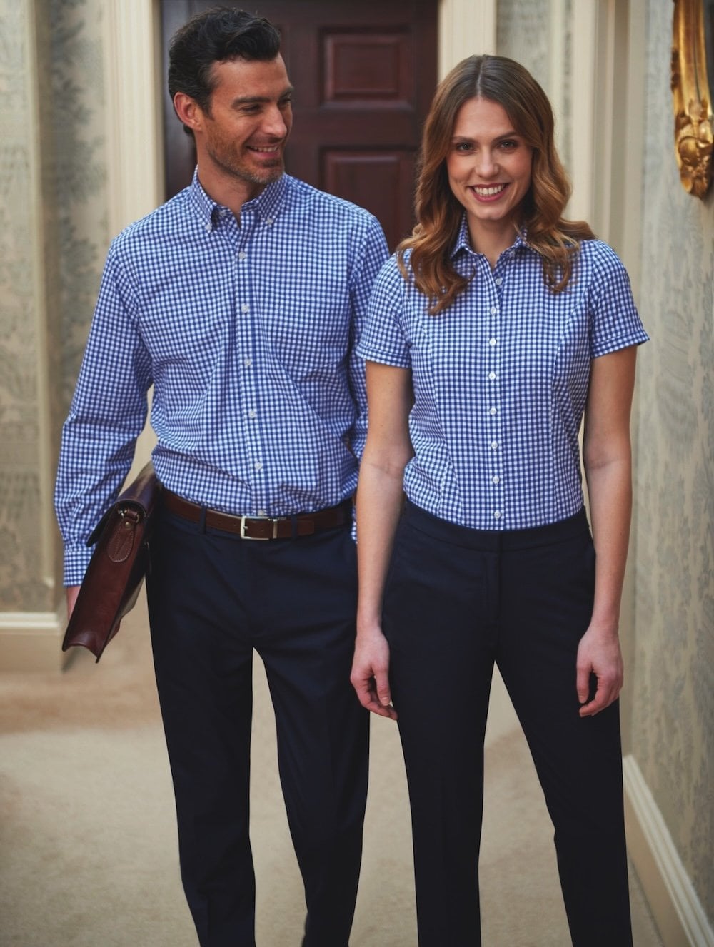 A man and a woman wearing blue check shirts
