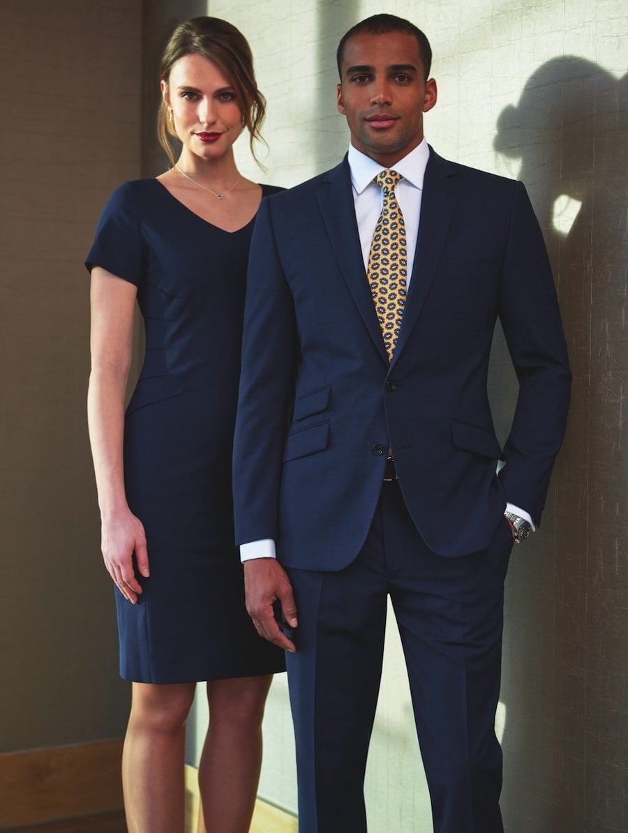 A man in a navy suit with a woman in a navy dress